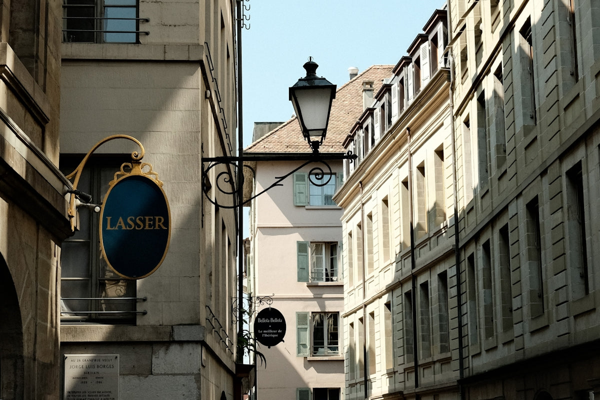 A city street with a clock on the side of a building